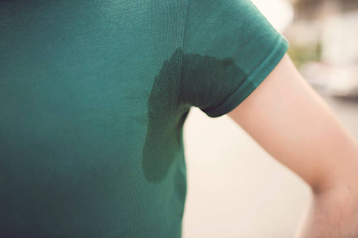 a green shirt with sweat stains