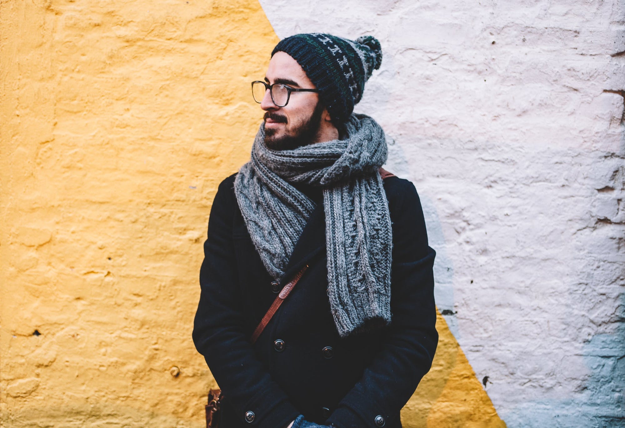 Man standing in a hat, coat and scarf