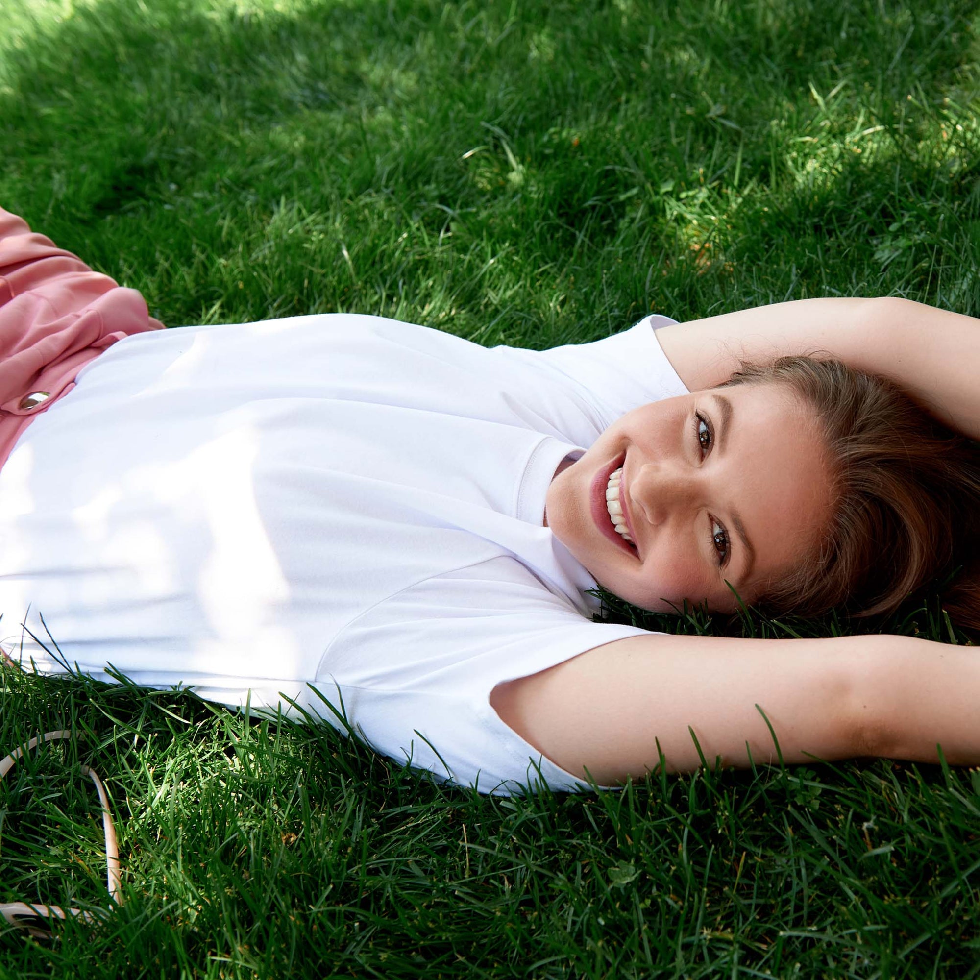 Woman on grass with a white shirt